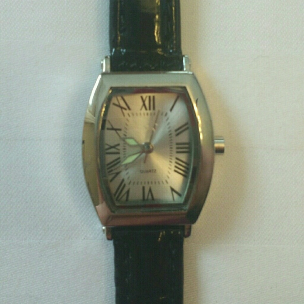 Silver tone watch with Roman numerals